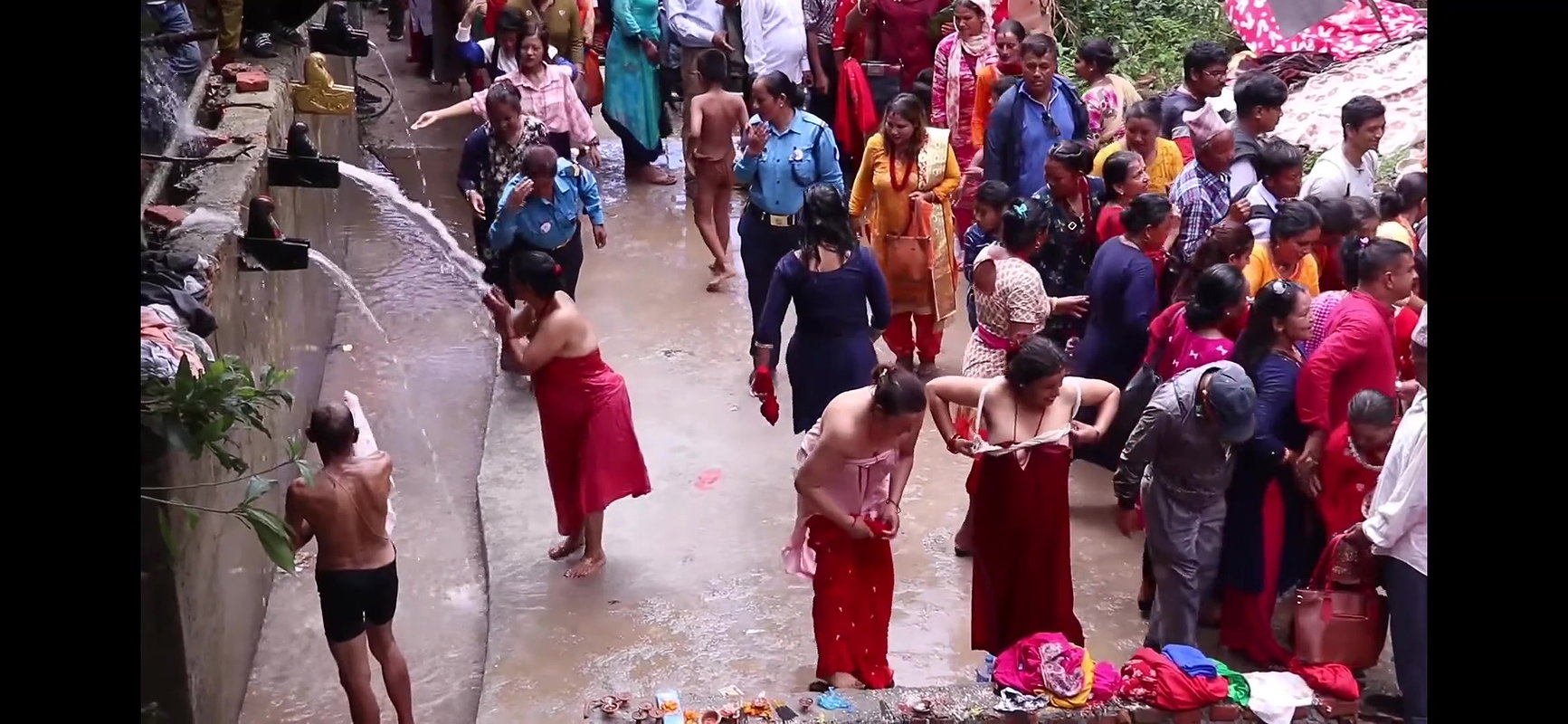 Multiple women wearing clothes after bath at ghat