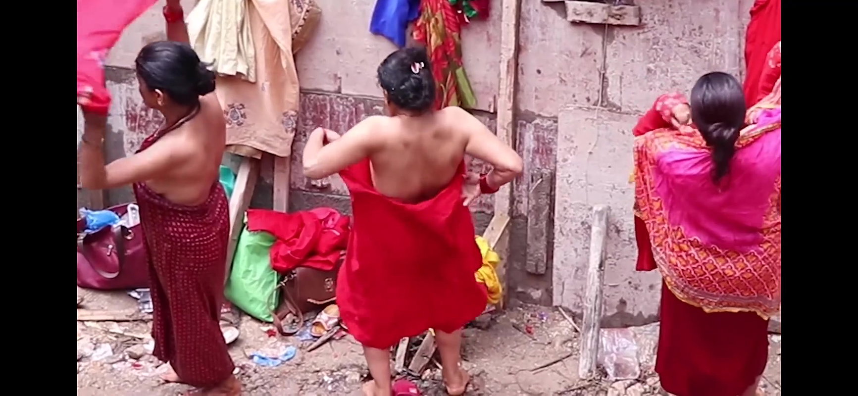 Multiple women wearing clothes after bath at ghat