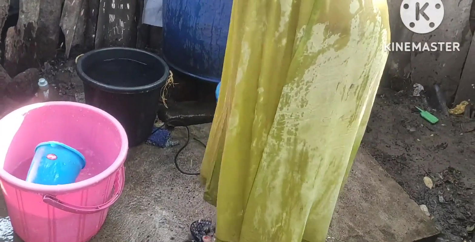 Bathing with cold water topless.