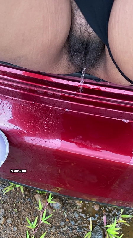 hot girl pissing on the way outside of the car boot.