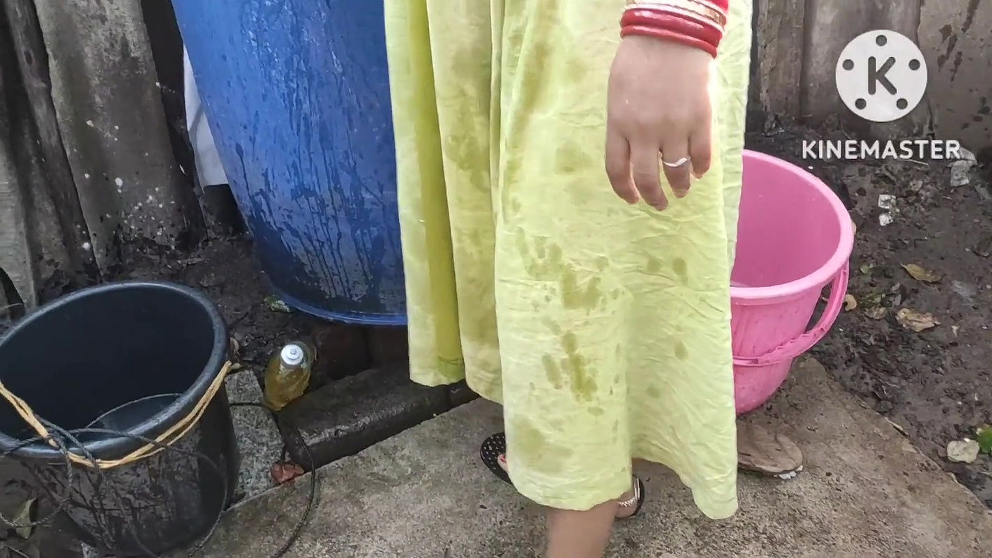indian housewife bathing outside with dance