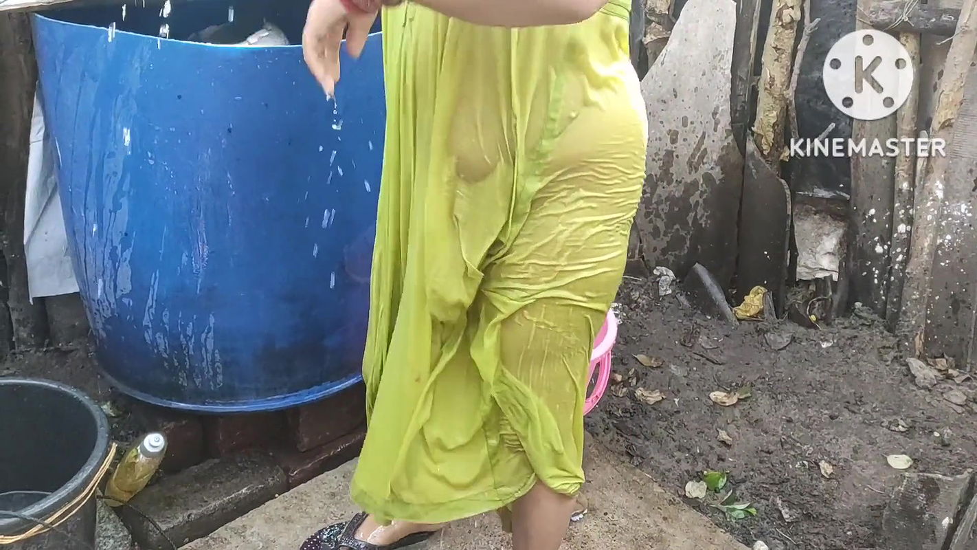 indian housewife bathing outside with dance