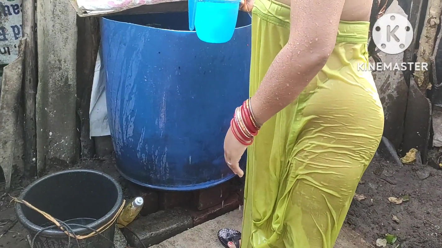 indian housewife bathing outside with dance
