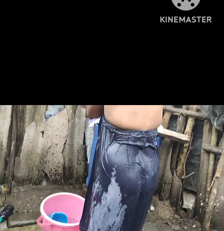 Indian house wife bathing outside