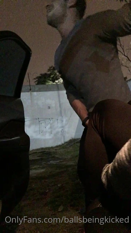 A girl in nature punishes a guy in the balls