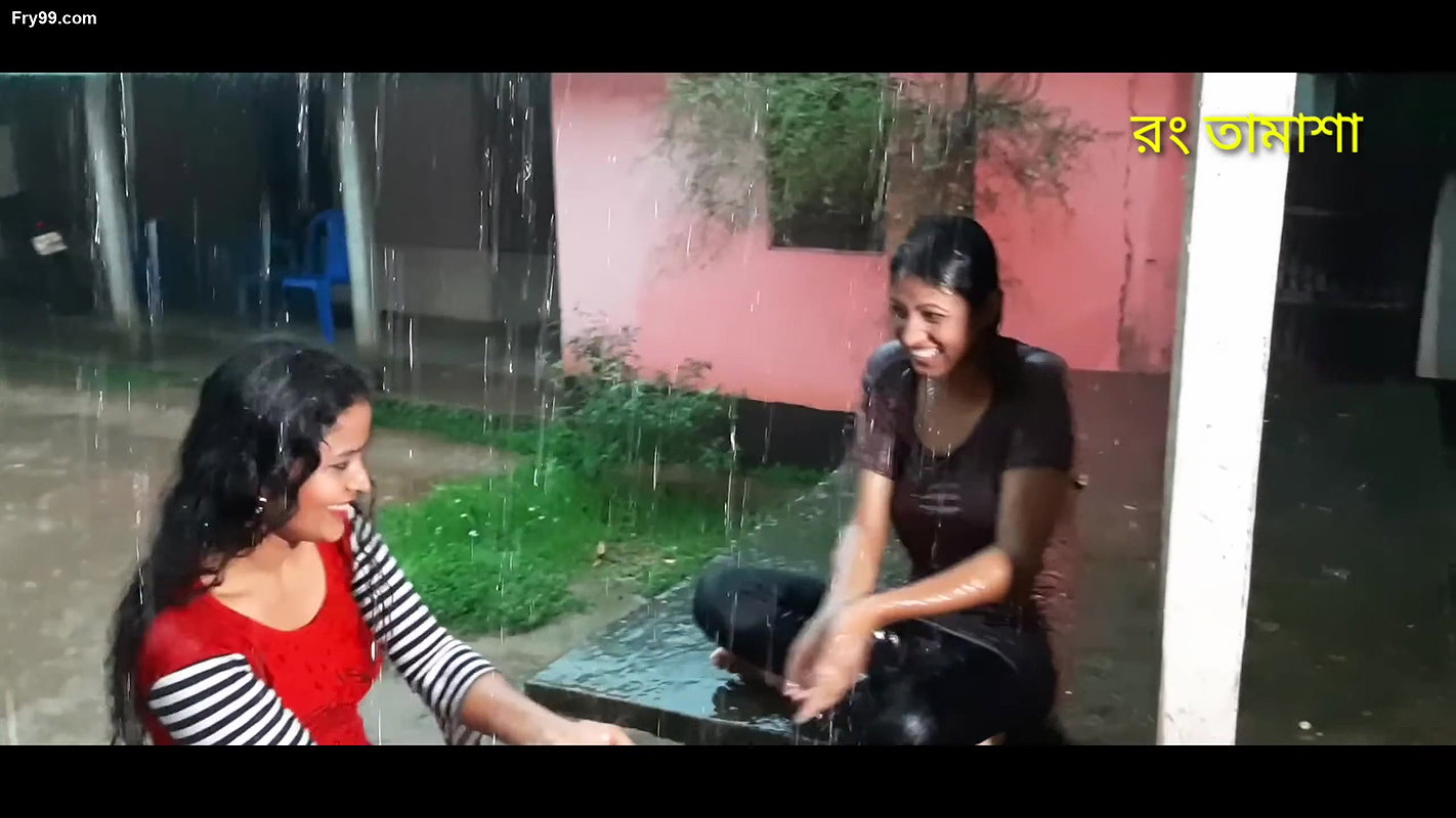 Two hot young girl enjoying in rain scene making