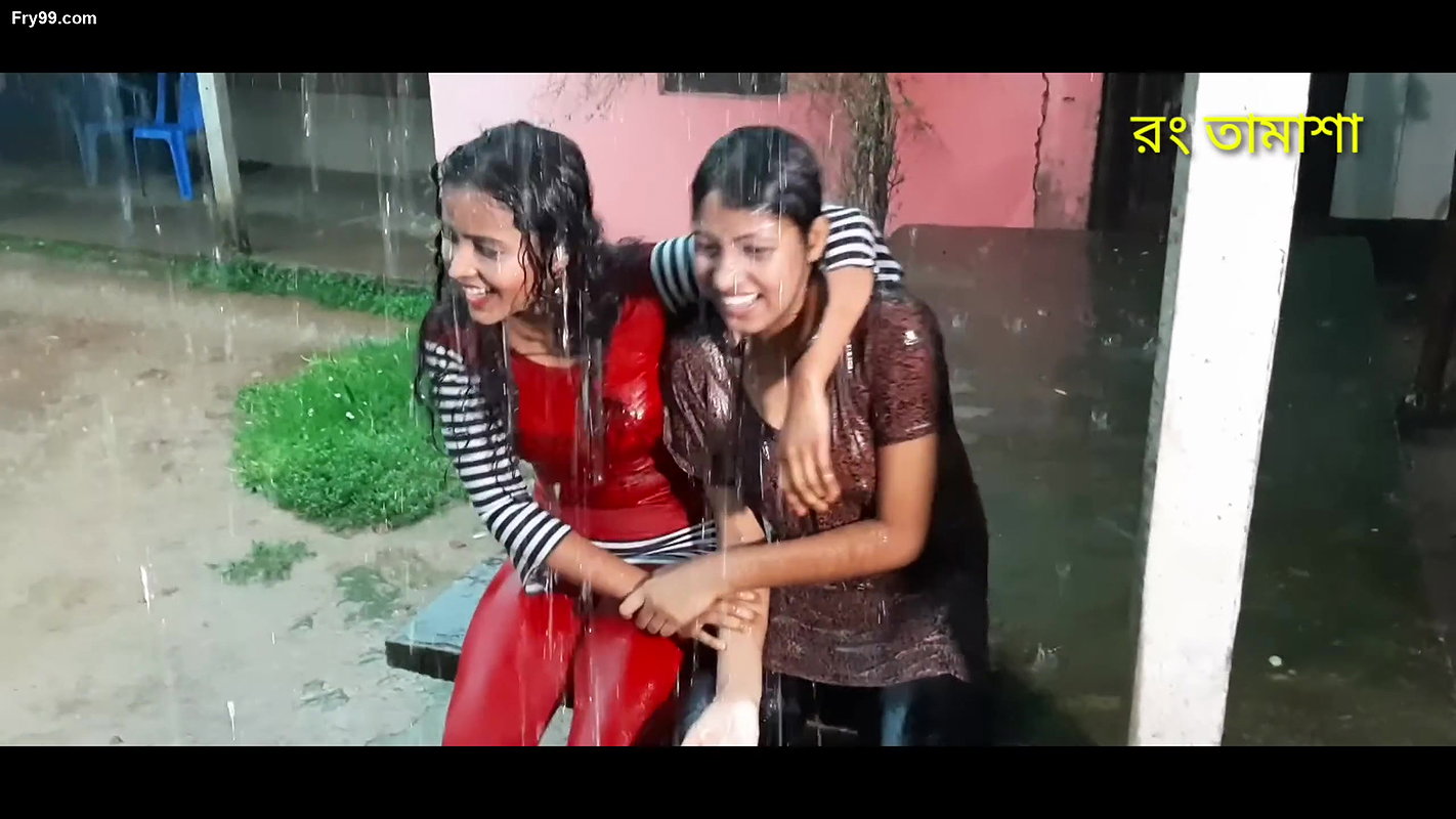 Two hot young girl enjoying in rain scene making
