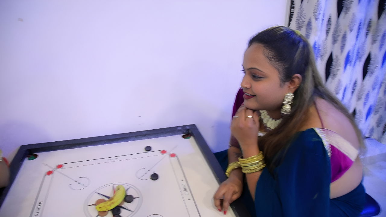 Two Girls Bet a Banana on the Carrom Game
